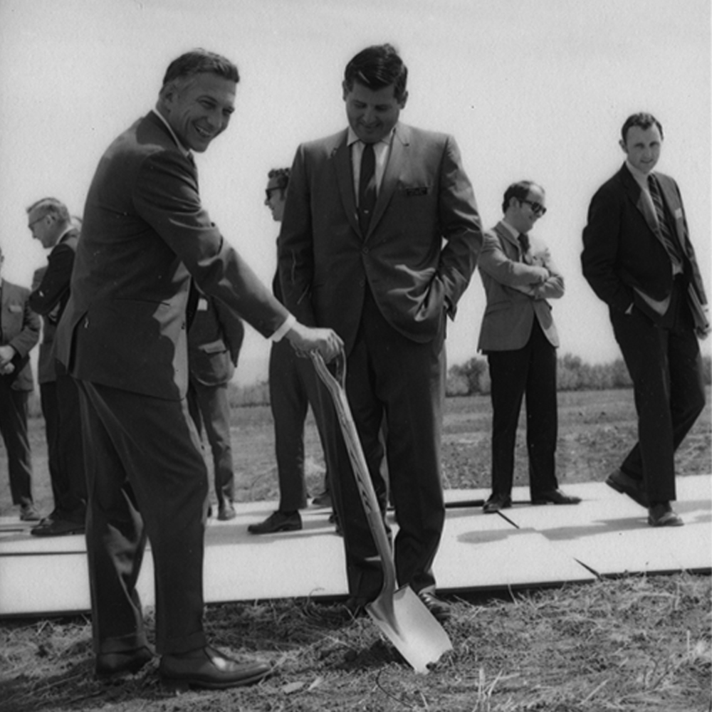 Robert Noyce handles a shovel at the ceremonial groundbreaking for the new facility, which would be known as Santa Clara 1. 